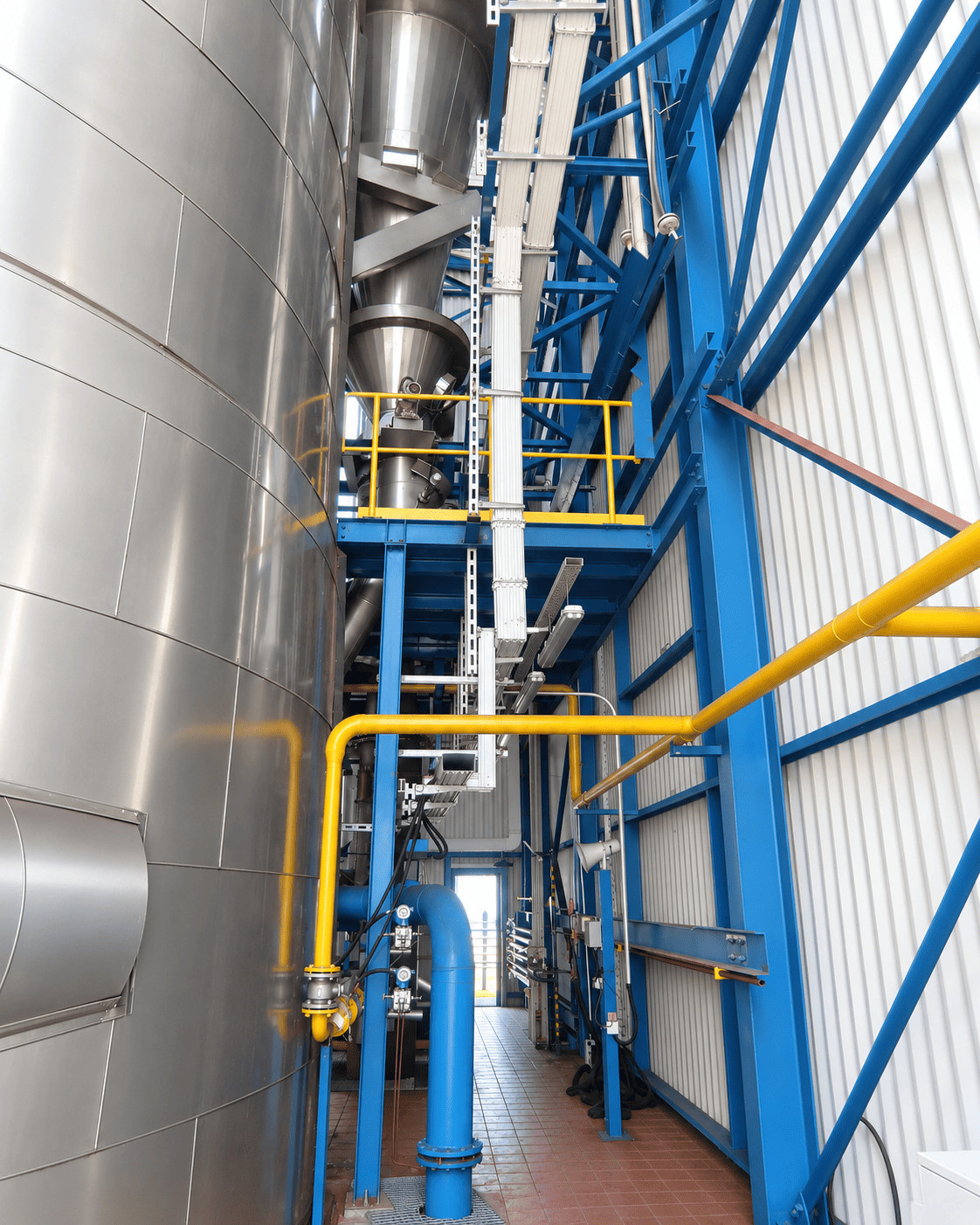 Industrial machinery with pipes and tanks in a manufacturing facility